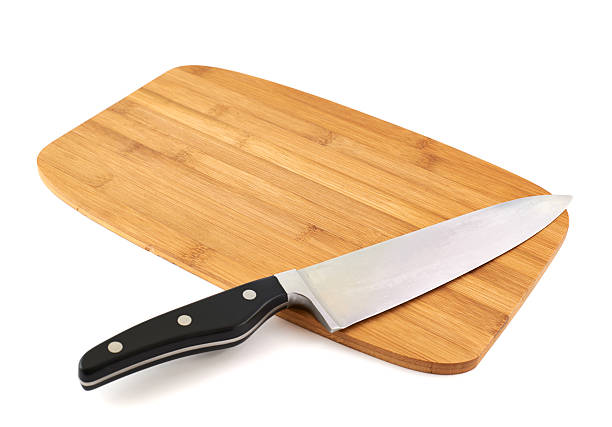 istock Knife over wooden cutting board 529064372