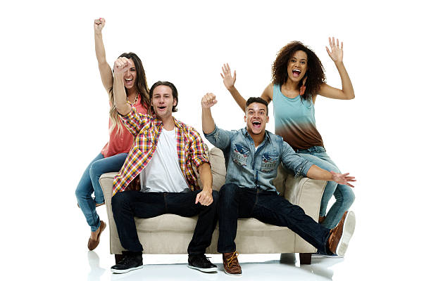 istock Cheerful four friends sitting on couch 529065591