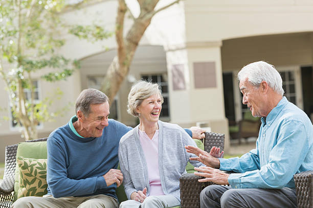 istock Seniors sitting on patio talking, laughing 529066878