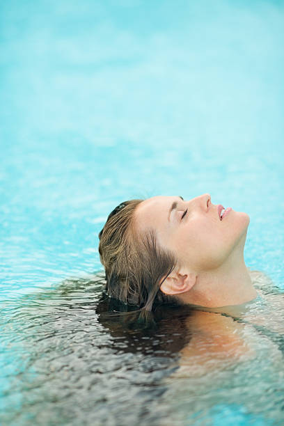 istock young woman swimming in pool 529066905