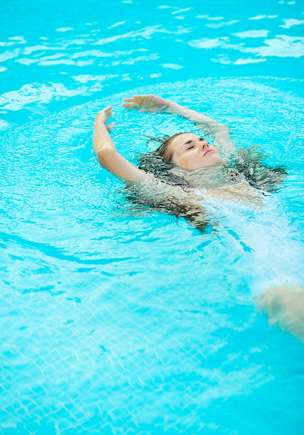 istock young woman swimming in pool 529067179