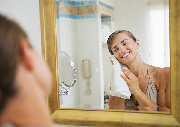 istock happy young woman towel in bathroom 529067409