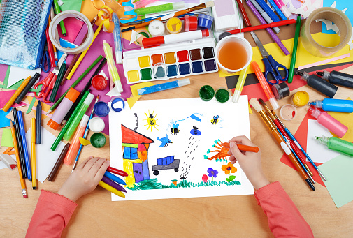 jumping car, animals and home having fun, child drawing , top view hands with pencil painting picture on paper, artwork workplace