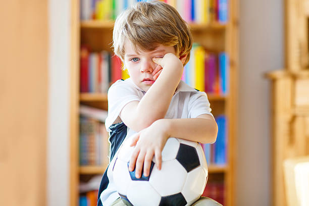 istock Kid boy sad about lost football or soccer game 529068586