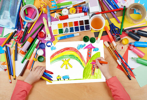 istock house in village child drawing, top view hands 529068782