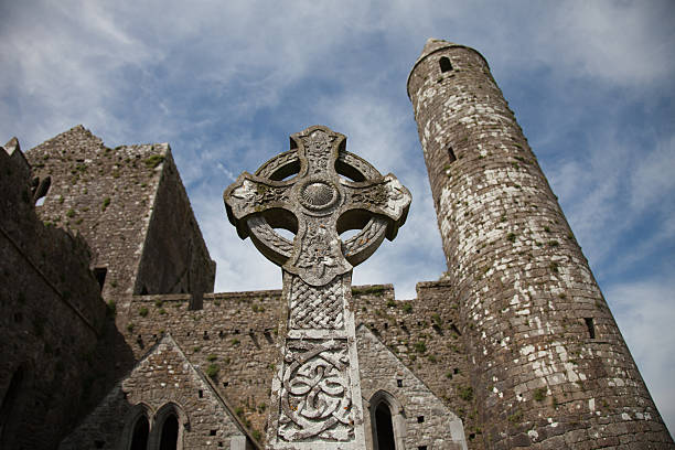 gravestone, round tower and cathedral at the historic 12th century Rock of Cashel, Cashel, Ireland