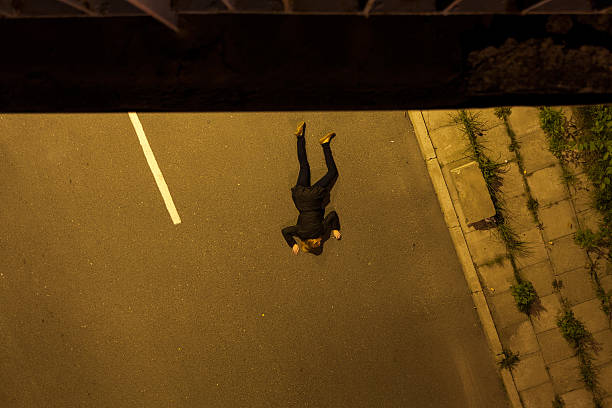 Horizontal view of suicide girl lying on a street