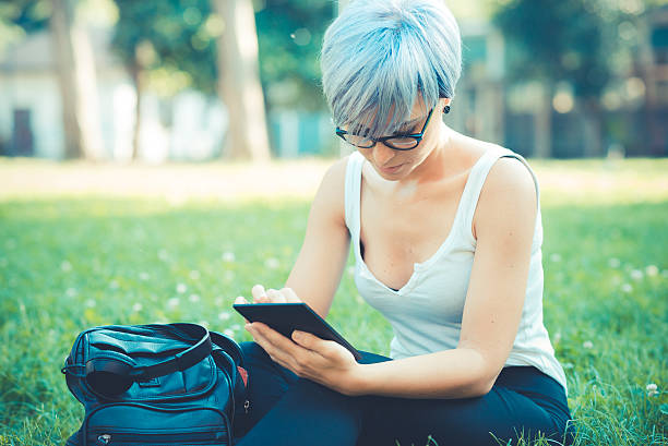 istock young beautiful short blue hair hipster woman using tablet 529072367