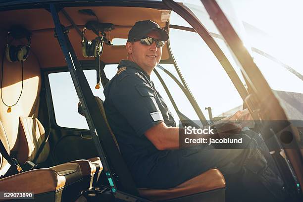 Happy Male Pilot In A Helicopter Cockpit Stock Photo - Download Image Now - Helicopter Pilot, Pilot, Adult