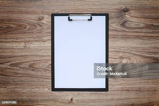 Blank White Paper Sheet A4 On Clipboard Wooden Background Stock Photo - Download Image Now