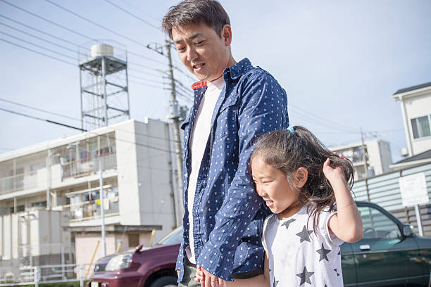 istock Father and daughter walking at a town 529077340