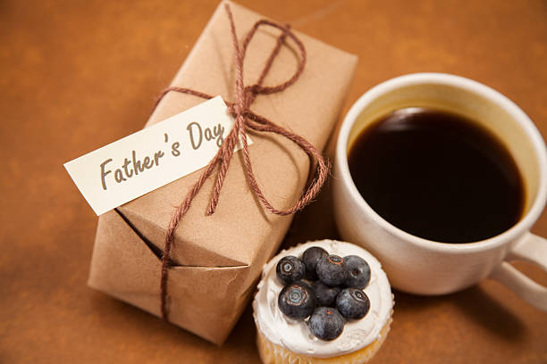 istock Holidays:  Father's Day wrapped gift for dad. Coffee, muffin. 529078694