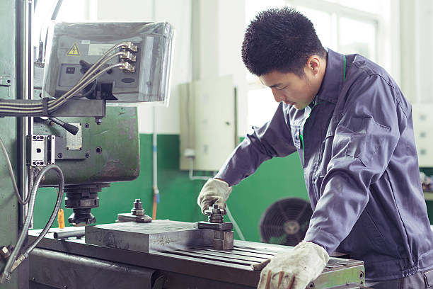 mechanic worker busy working on machine in factory