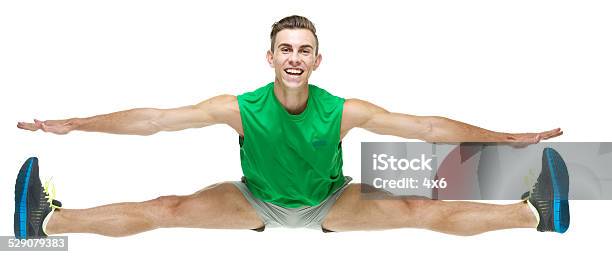 Front View Of Happy Male Athlete Jumping Stock Photo - Download Image Now - 20-29 Years, Adult, Adults Only