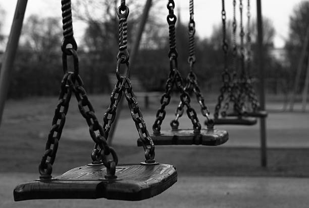 istock Black and white swings in play park 529079644