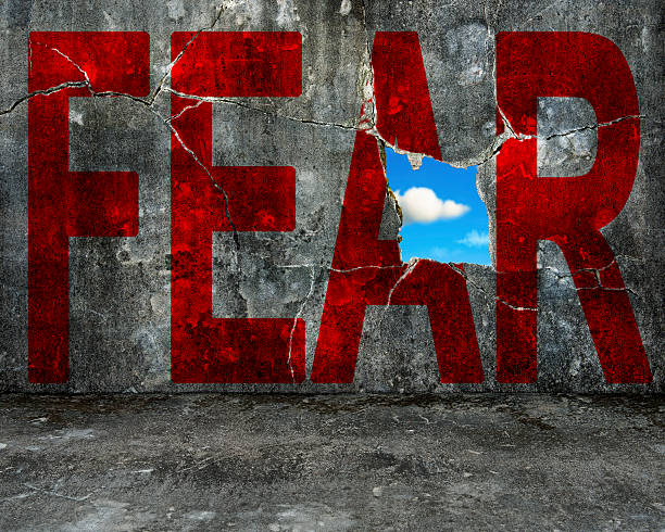 red FEAR word on grey grunge concrete wall stock photo
