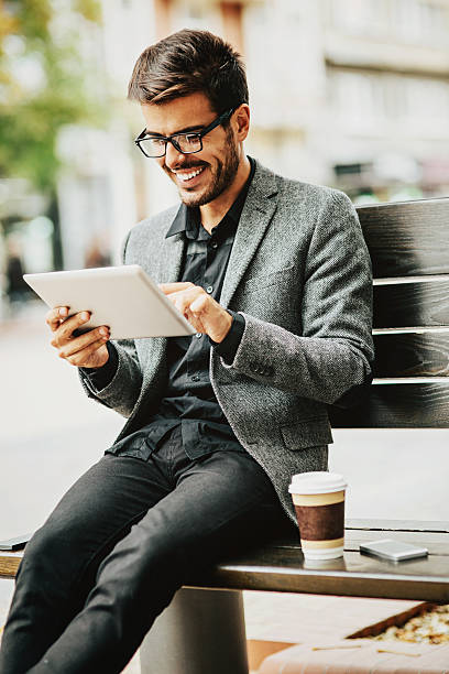 istock Casual businessman with digital tablet outdoors 529079921