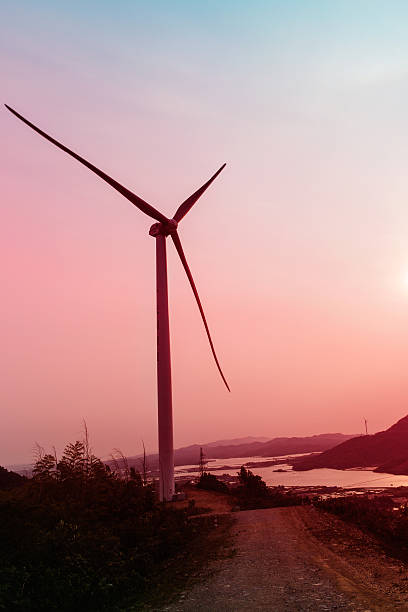 istock sunset sky and wind turbine 529080106