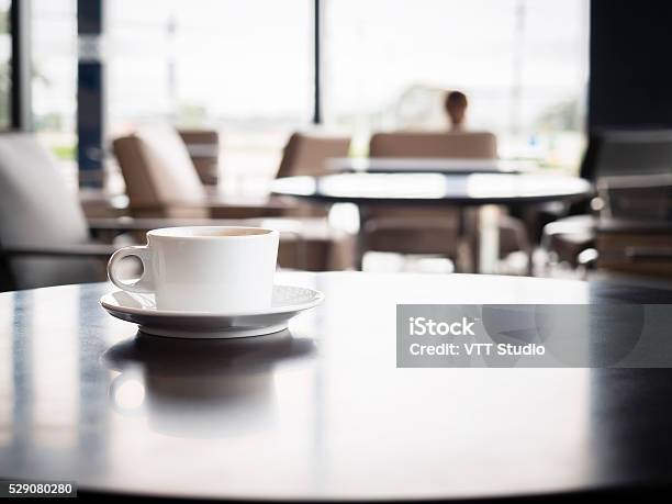 Coffee Cup On Table With Blurred People In Restaurant Interior Stock Photo - Download Image Now