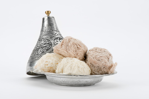 Traditional Turkish cotton candy called Pismaniye in vintage plate over white background. 