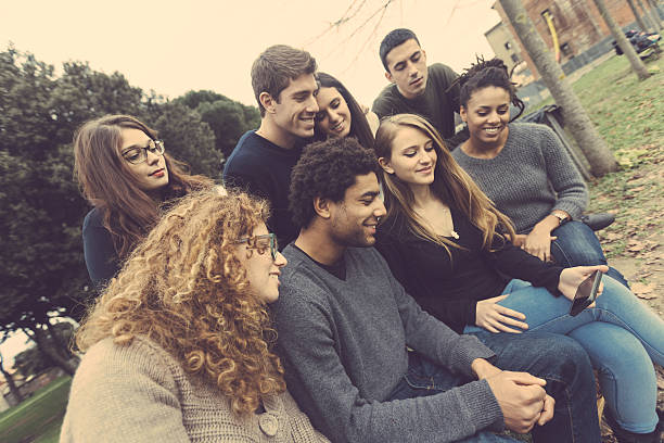 istock Multiethnic Group of Friends Looking at Mobile Phone 529081081