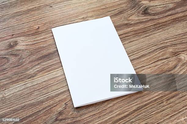 Blank Of Brochure Is On A Wooden Desk Stock Photo - Download Image Now - Table, Template, Magazine - Publication