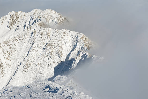 istock Alpine landscape with peaks covered by snow and clouds 529081465