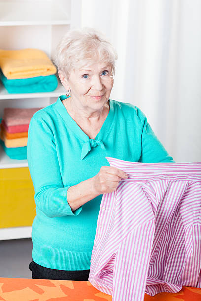 istock Senior woman ironing shirt 529082499