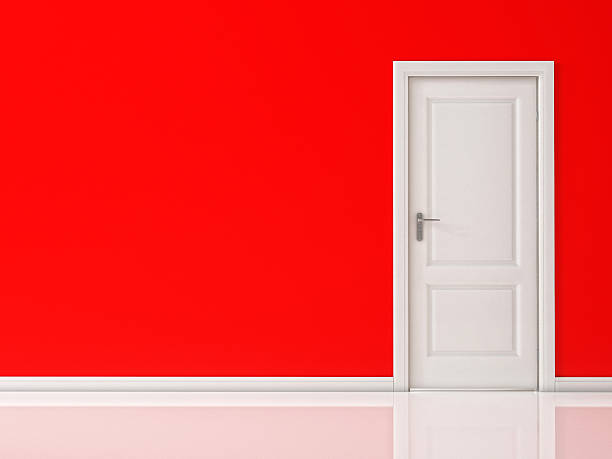 istock Closed White Door on Red Wall, Reflective Floor 529082749