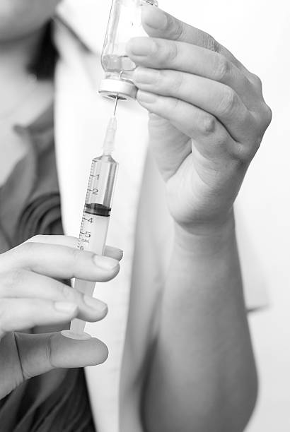 istock Doctor with syringe in hands, getting ready for injection 529084429
