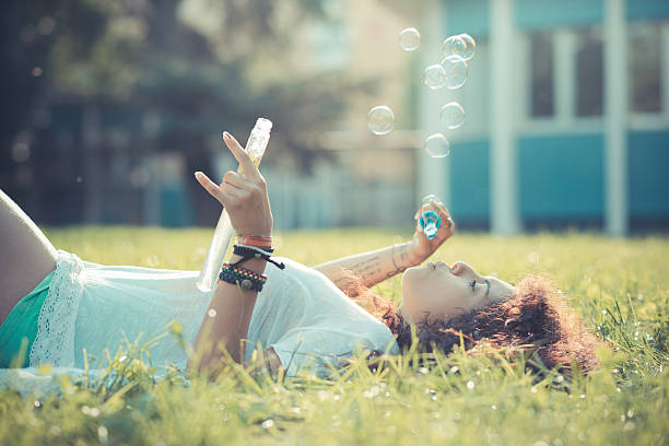 istock young beautiful moroccan curly woman blowing bubbles 529085403