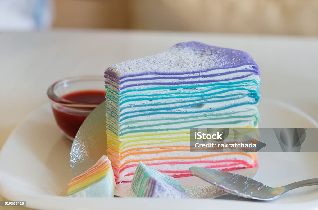 Rainbow crepe cake Rainbow crepe cake served with strawberry sauce Baked Stock Photo