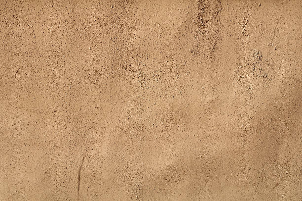 istock Texture of old wall covered with yellow stucco 529085491