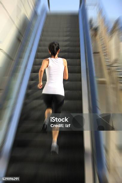 Runner Athlete Running On Escalator Stairs Stock Photo - Download Image Now - Active Lifestyle, Activity, Adult