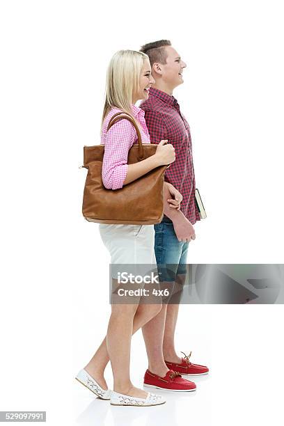 Smiling Two Student Holding Books Looking Away Stock Photo - Download Image Now - 16-17 Years, Back to School, Bag