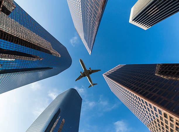 istock Airplane flying above skyscrapers in Los Angesles 529098399