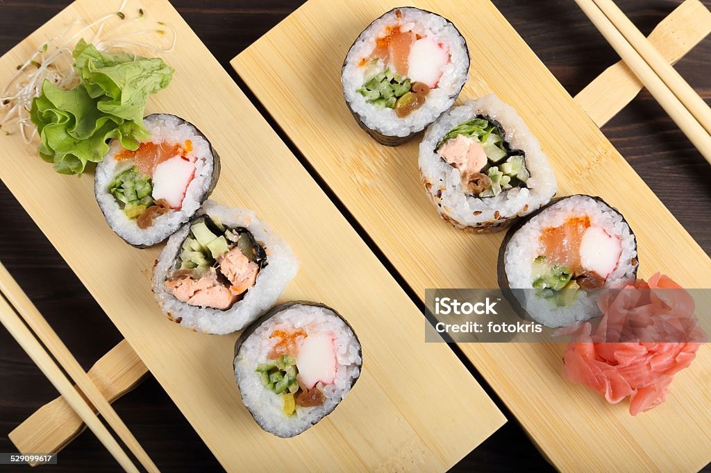 Sushi Japanese food, sushi with ginger and lettuce on bamboo geta. Appetizer Stock Photo