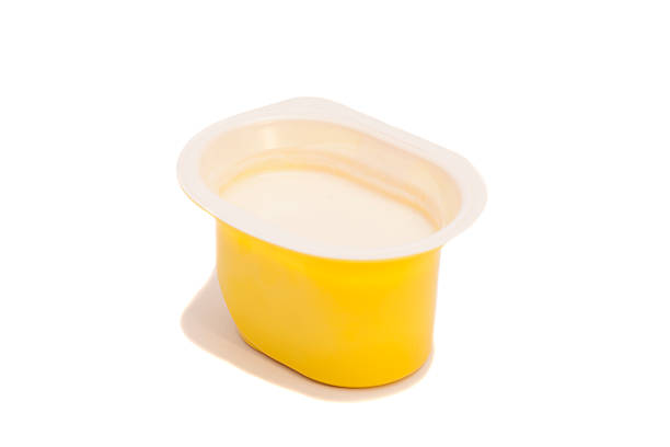 istock Peach yogurt in opened yogurt pot isolated on white 529101361