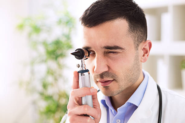 istock Doctor looking through otoscope 529114558