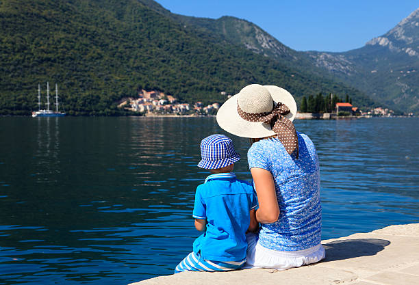 istock mother and son looking at scenic sea view 529115329