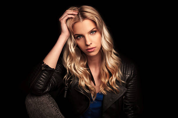 istock young woman in leather jacket resting her head on  palm 529116422