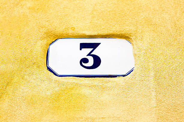 istock Number 3 Ceramic Street Address Tile On Vibrant Yellow Wall 529116578
