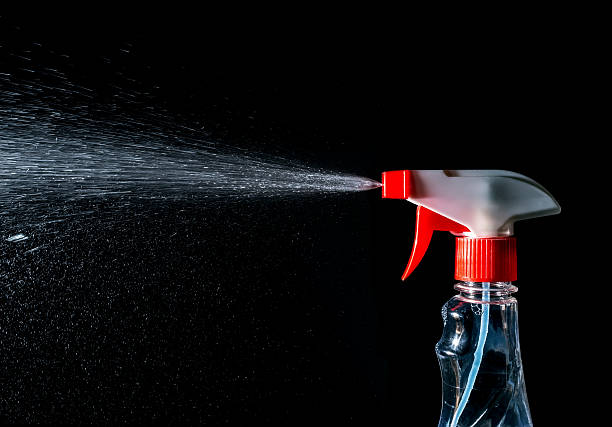 istock cleaner spray, stream of cleaner spray isolated on a black 529117420