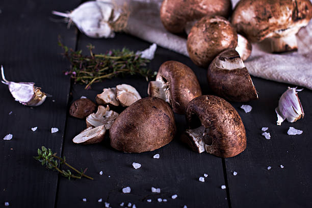istock Fresh mushrooms with spices and herbs on a black board. 529117966