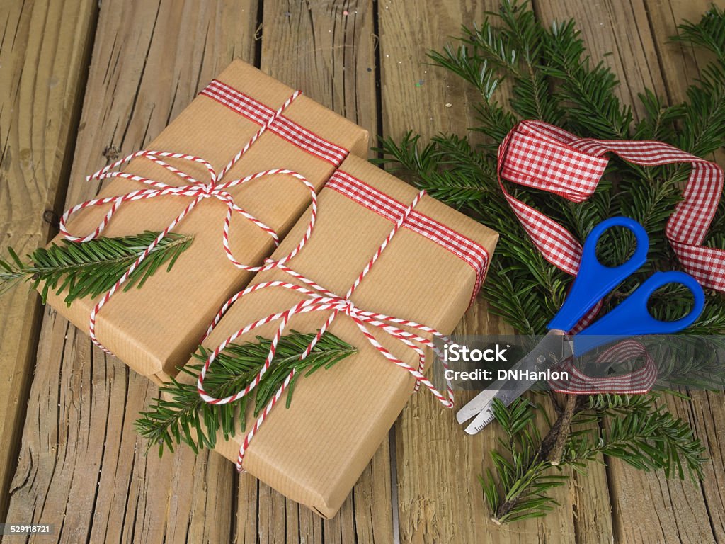 String And Brown Paper Parcels With Conifer Decoration Check Ri Stock Photo  - Download Image Now - iStock
