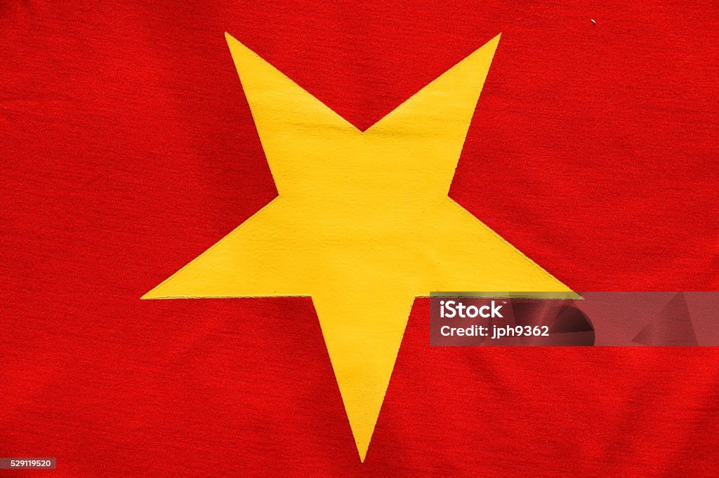 Red flag gold star Reminiscent of the Vietnamese "red flag with a gold star", this image captures a yellow star against a red background Flag Stock Photo