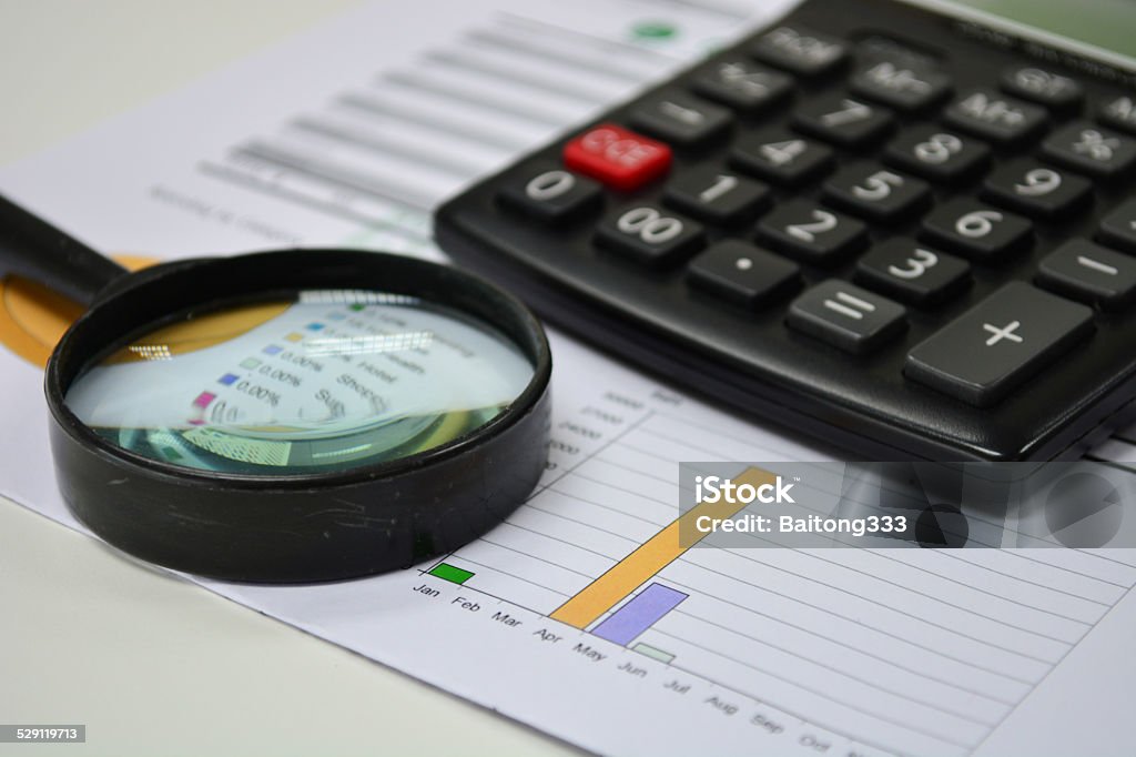 Business analytics. Calculator, financial reports Analyzing Stock Photo