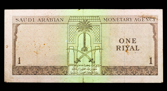 Old Saudi Arabian banknotes Isolated on a black background.