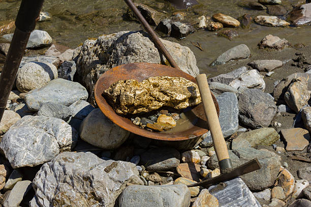 Gold Nugget mining from the River Gold Nugget mining from the River, with a gold pan, and find some big gold nugget. sluice photos stock pictures, royalty-free photos & images