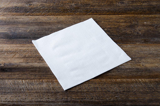 Napkin on wooden table. Top view.